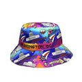 A colorful bucket hat featuring a vibrant Washington, DC themed print with illustrations of landmarks, stars, and the phrase 'CAPITOL' on a purple band, set against a plain white background.