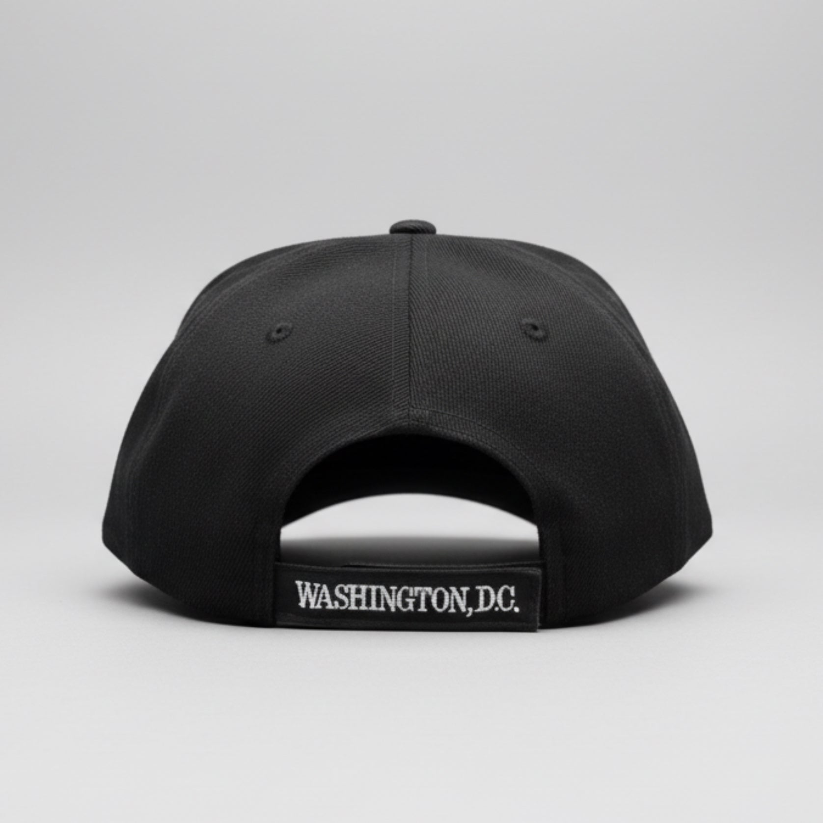 Black cap with 'Washington DC' logo on a reflective surface